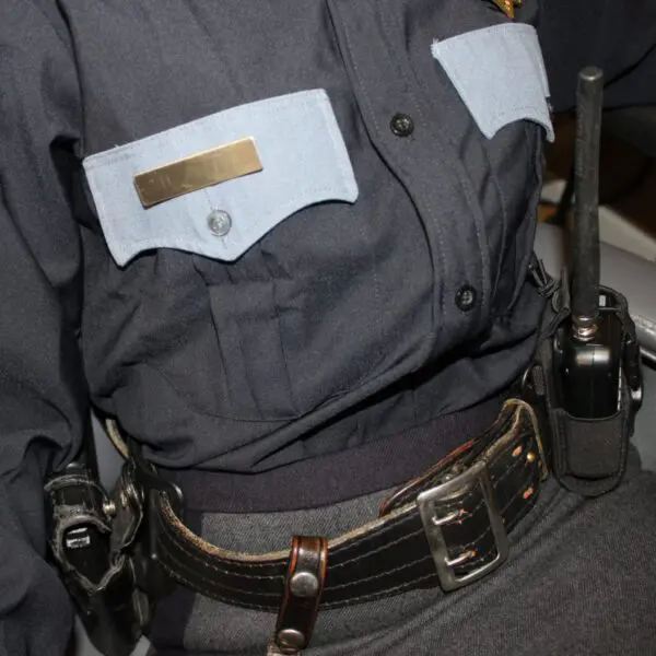 Police uniform with radio and belt.