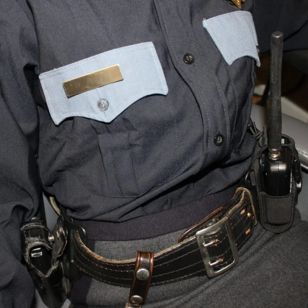 Police uniform with radio and belt.