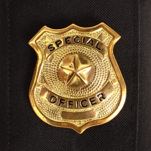Special officer badge on black fabric background.